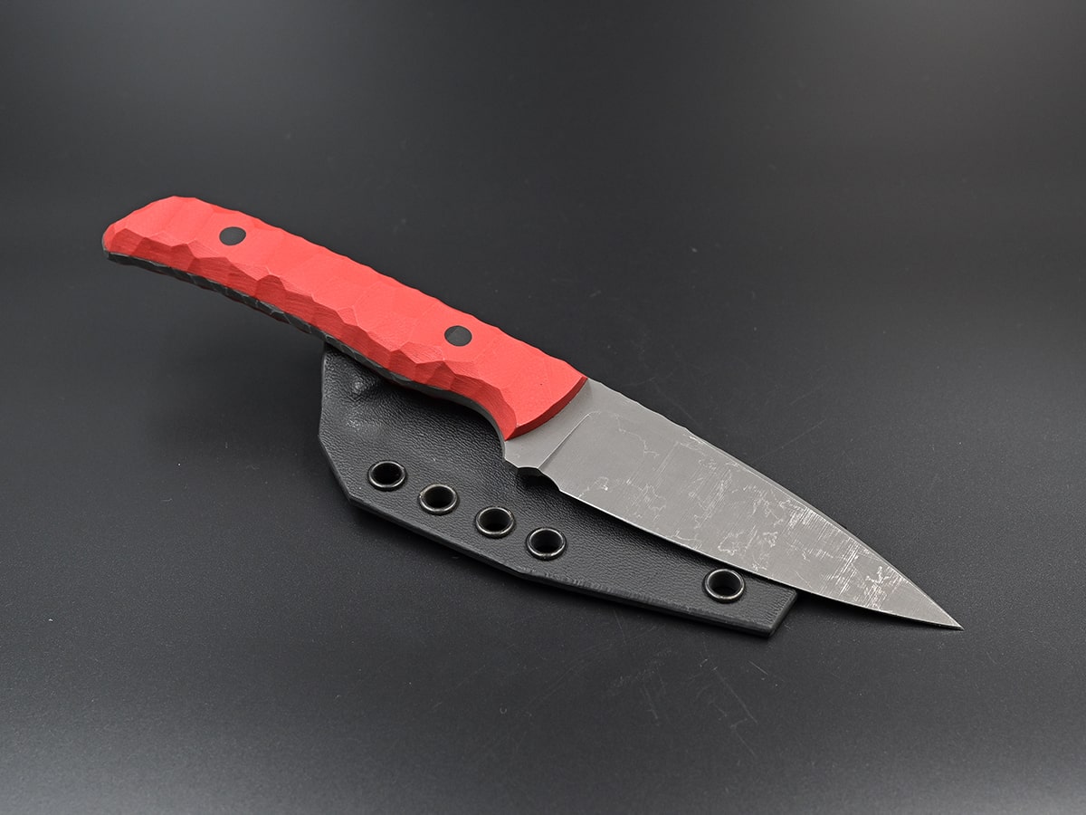 Phobos the all-purpose knife with stonewash finish and rockpattern handle.
