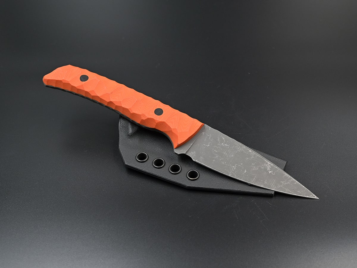 Phobos the All Purpose knife with a pointy tip and orange G10 handle
